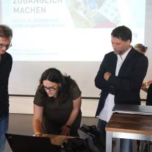 leute beim Podium richten laptop ein